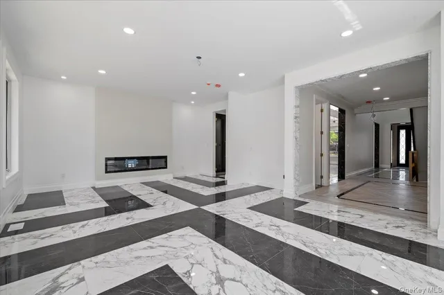 a large white kitchen with a large counter top
