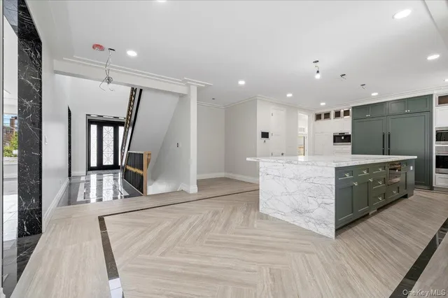 a large room with lots of counter space and wooden floor