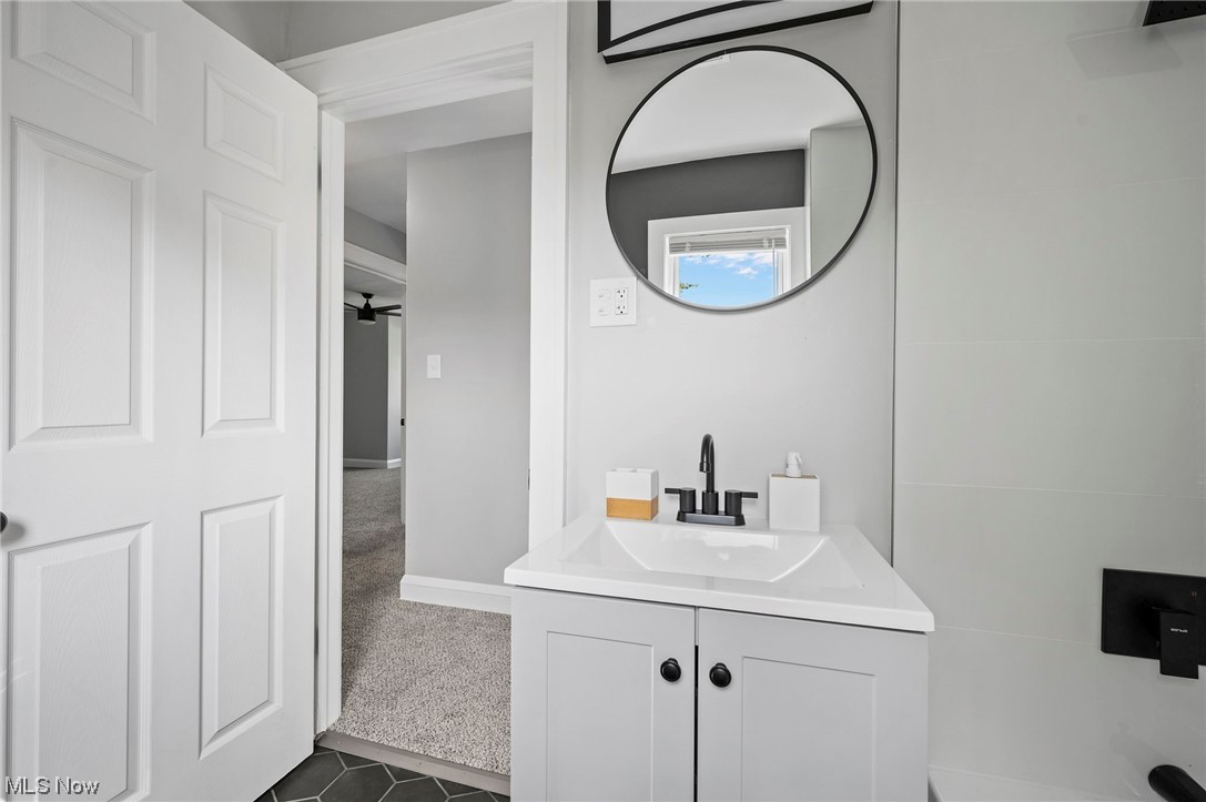 1022 Englewood Road Cleveland, OH 44121 - Photo 23 of 33 Bathroom with vanity with extensive cabinet space, ceiling fan, and tile flooring