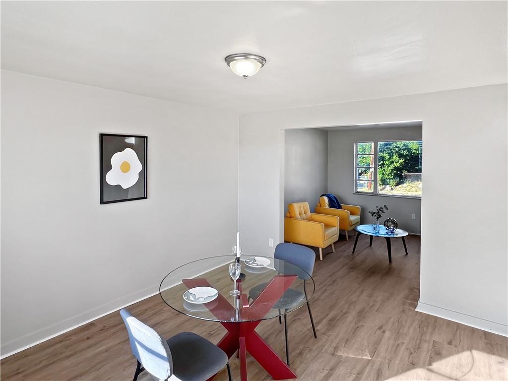 6444 Apple Street Pittsburgh, PA 15206 - Photo 5 of 28 a view of a dining room with furniture window and wooden floor