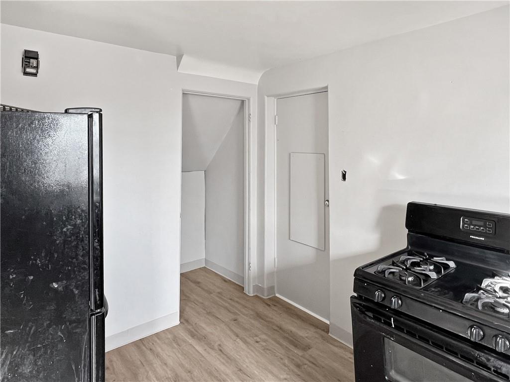 6444 Apple Street Pittsburgh, PA 15206 - Photo 7 of 28 a kitchen with a stove and a refrigerator