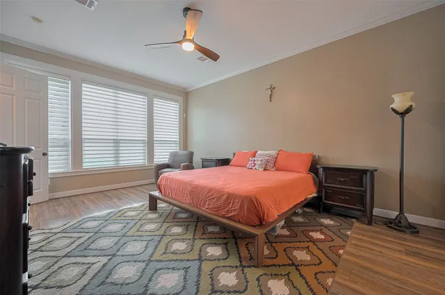 a bedroom with a bed and wooden floor