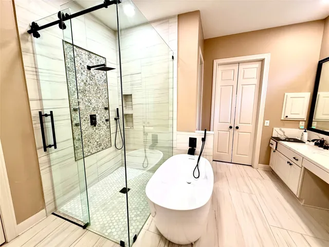 a spacious bathroom with a tub and shower
