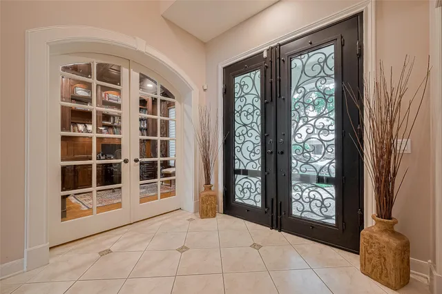 a view of an entryway with wooden floor and garden