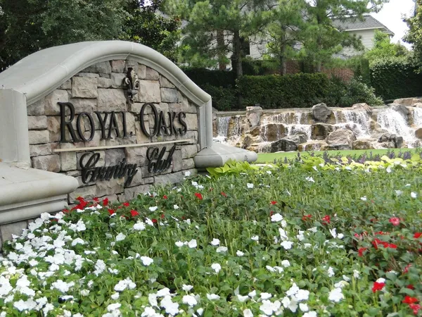 a view of sign board with yard and green space