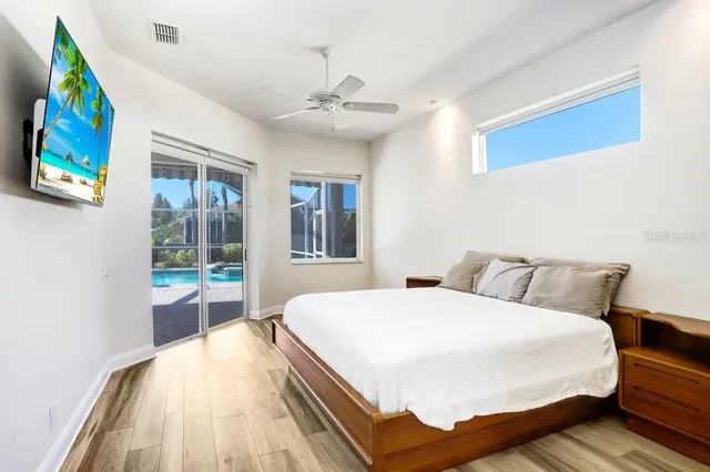 a bedroom with a bed and a large window