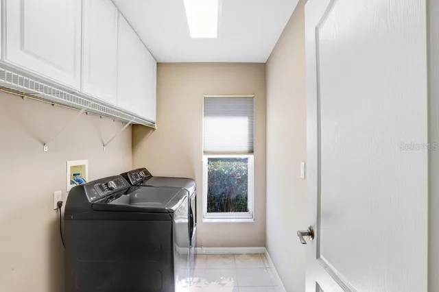 a utility room with sink dryer and washer