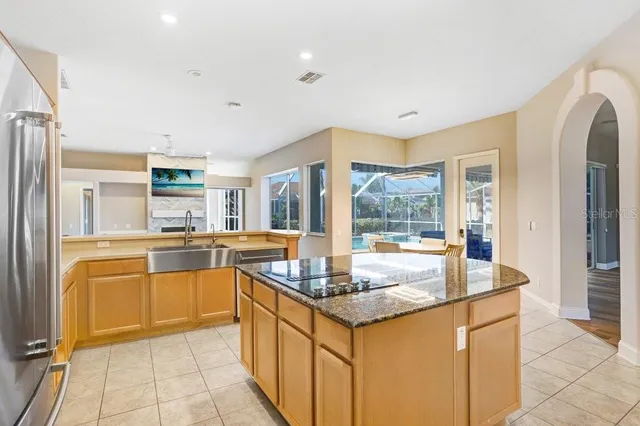 a large kitchen with kitchen island granite countertop a large window and counter space