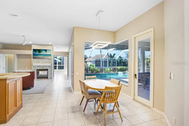 a dining room with furniture a chandelier and fireplace