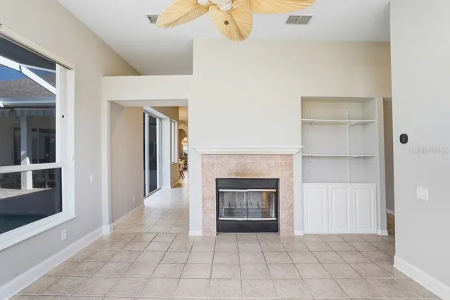 a view of an empty room and fire place