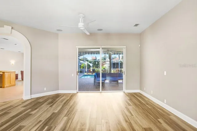 a view of empty room with wooden floor