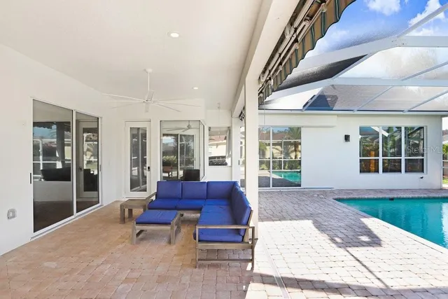 a view of a patio with a table and chairs under an umbrella