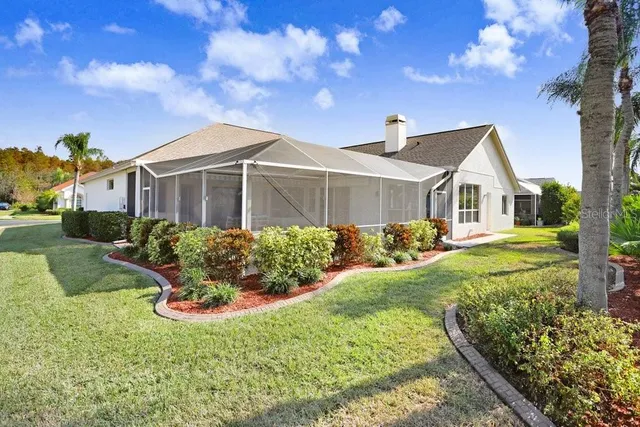 an aerial view of residential houses with outdoor space and ocean view