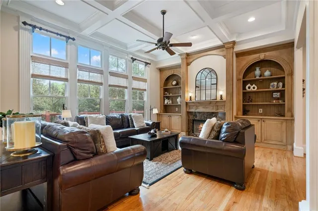 a living room with furniture and a wooden floor