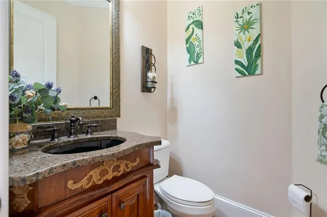 a kitchen with stainless steel appliances kitchen island granite countertop a refrigerator a stove and a wooden floors