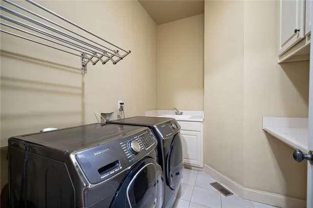 a bathroom with a vanity sink and large mirror