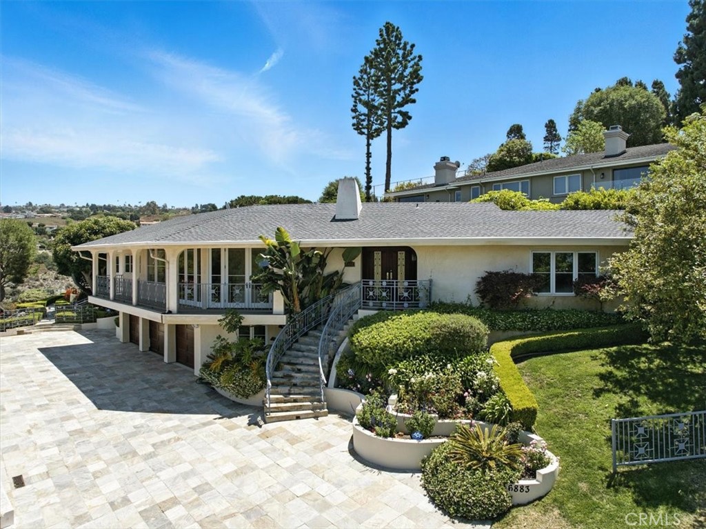 6883 Crest Road Rancho Palos Verdes, CA 90275 - Photo 1 of 1 a front view of a house with a yard and potted plants