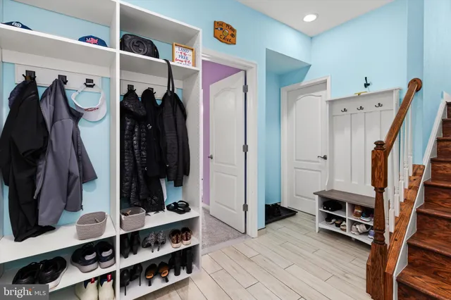 a view of a dining room with furniture a kitchen and stainless steel appliances