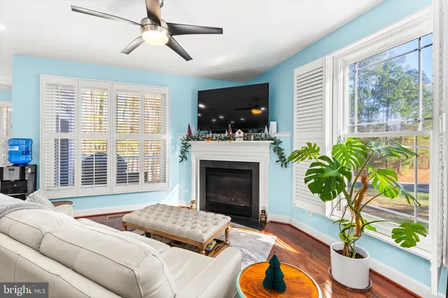 a bathroom with a shower a sink and a window
