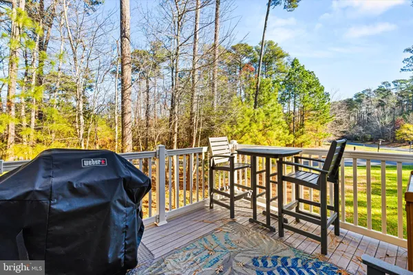 a view of a patio with couches table and chairs and wooden floor