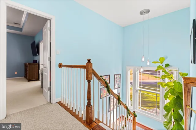a room with furniture pool table and wooden floor