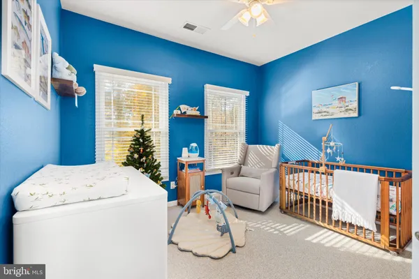 a view of a dining room with furniture a chandelier and wooden floor