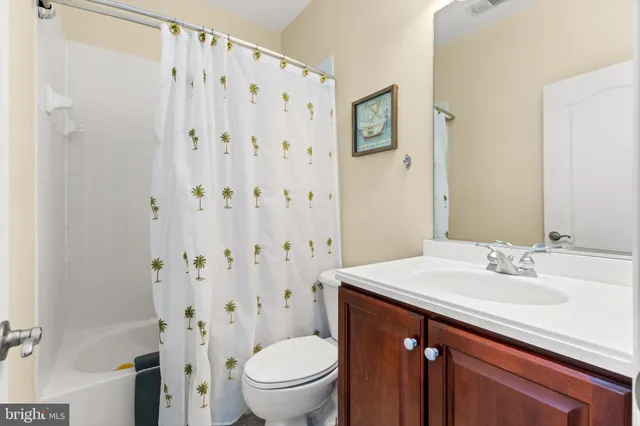 a view of a lake with boats and trees in the background