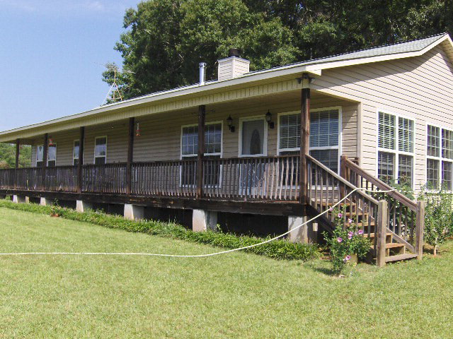 a view of a house with a yard and sitting area