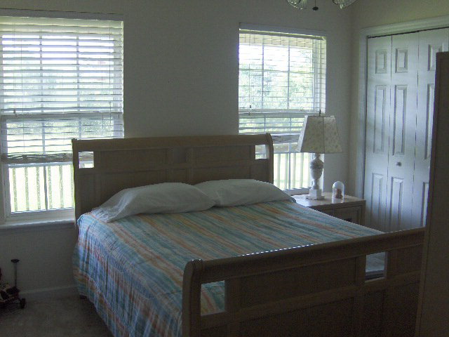 174 Buck Road Gray, GA 31032 - Photo 12 of 25 a bed sitting in a bedroom next to a window