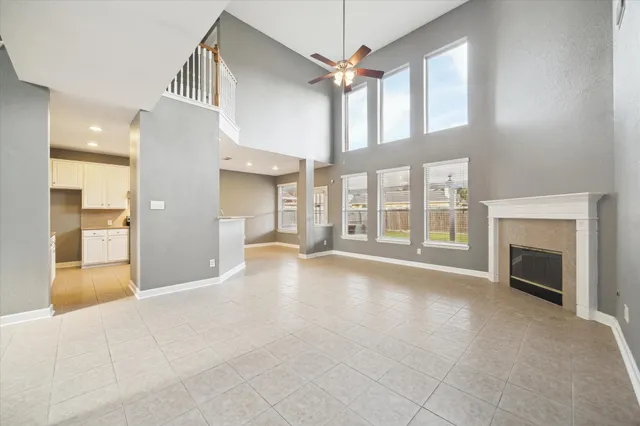 a view of an empty room with a fireplace and a window