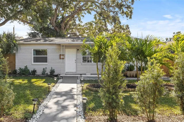 a view of a house with swimming pool and sitting area