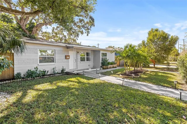 a view of a house with swimming pool and a yard