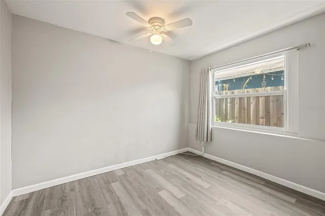 a view of an empty room and wooden floor