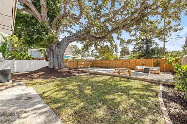 a view of a backyard with wooden fence