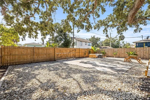 a backyard of a house with barbeque oven and outdoor seating
