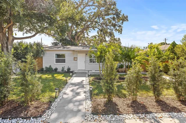 a backyard of a house with table and chairs