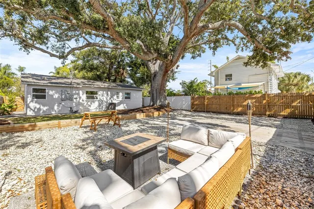 a view of yard with tree in front of it