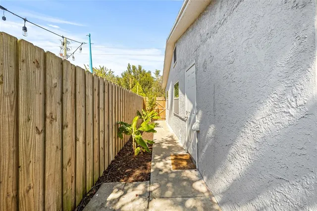a view of a yard with wooden fence