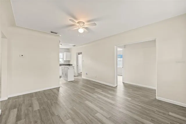 a view of an empty room and wooden floor