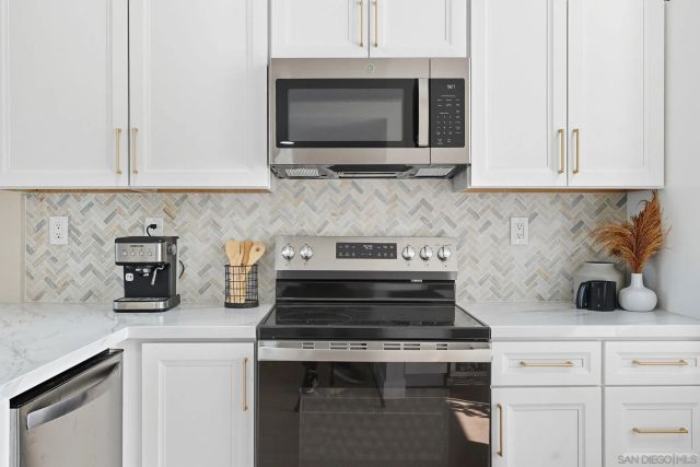 a kitchen with microwave cabinets and stove top oven