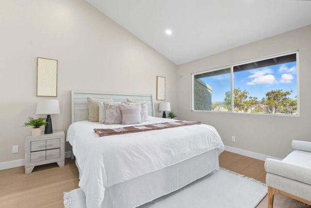 a bedroom with a bed and a painting on the wall