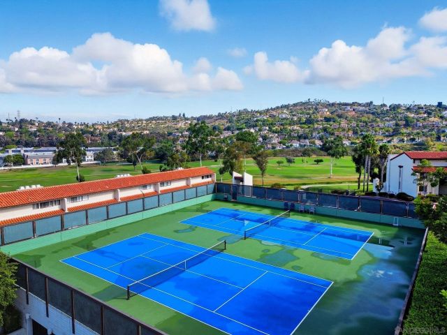 a view of a big yard with a garden and lake view
