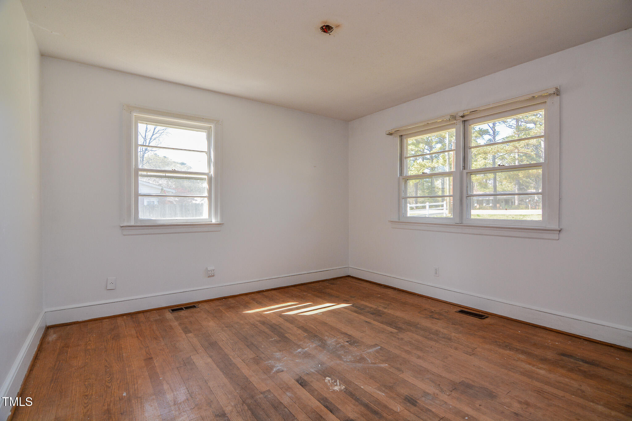 408 Rand Road Raleigh, NC 27603 - Photo 21 of 60 a view of a room with wooden floor and windows in it