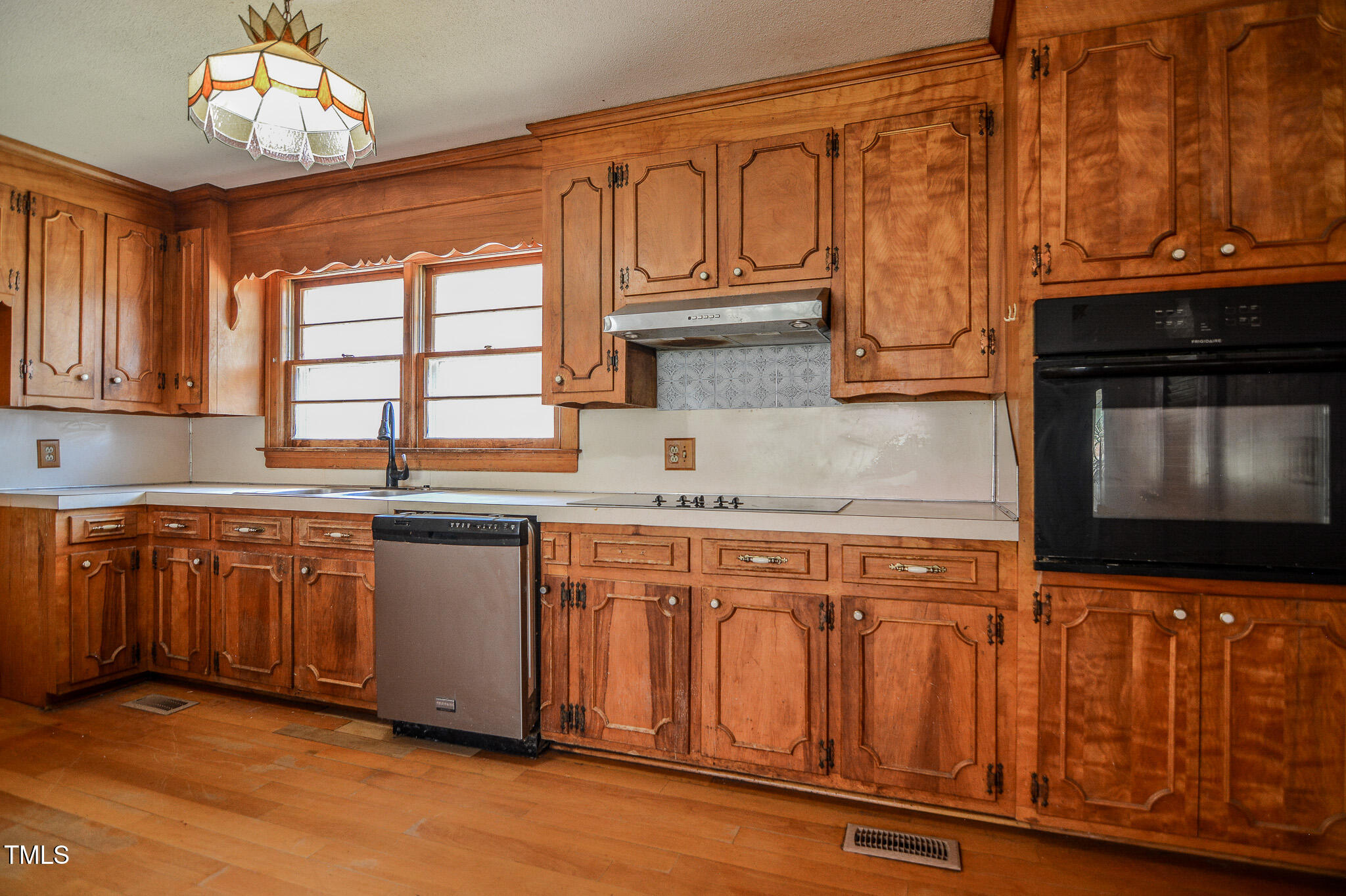 408 Rand Road Raleigh, NC 27603 - Photo 51 of 60 a kitchen with stainless steel appliances granite countertop a stove top oven a sink dishwasher and cabinets with wooden floor