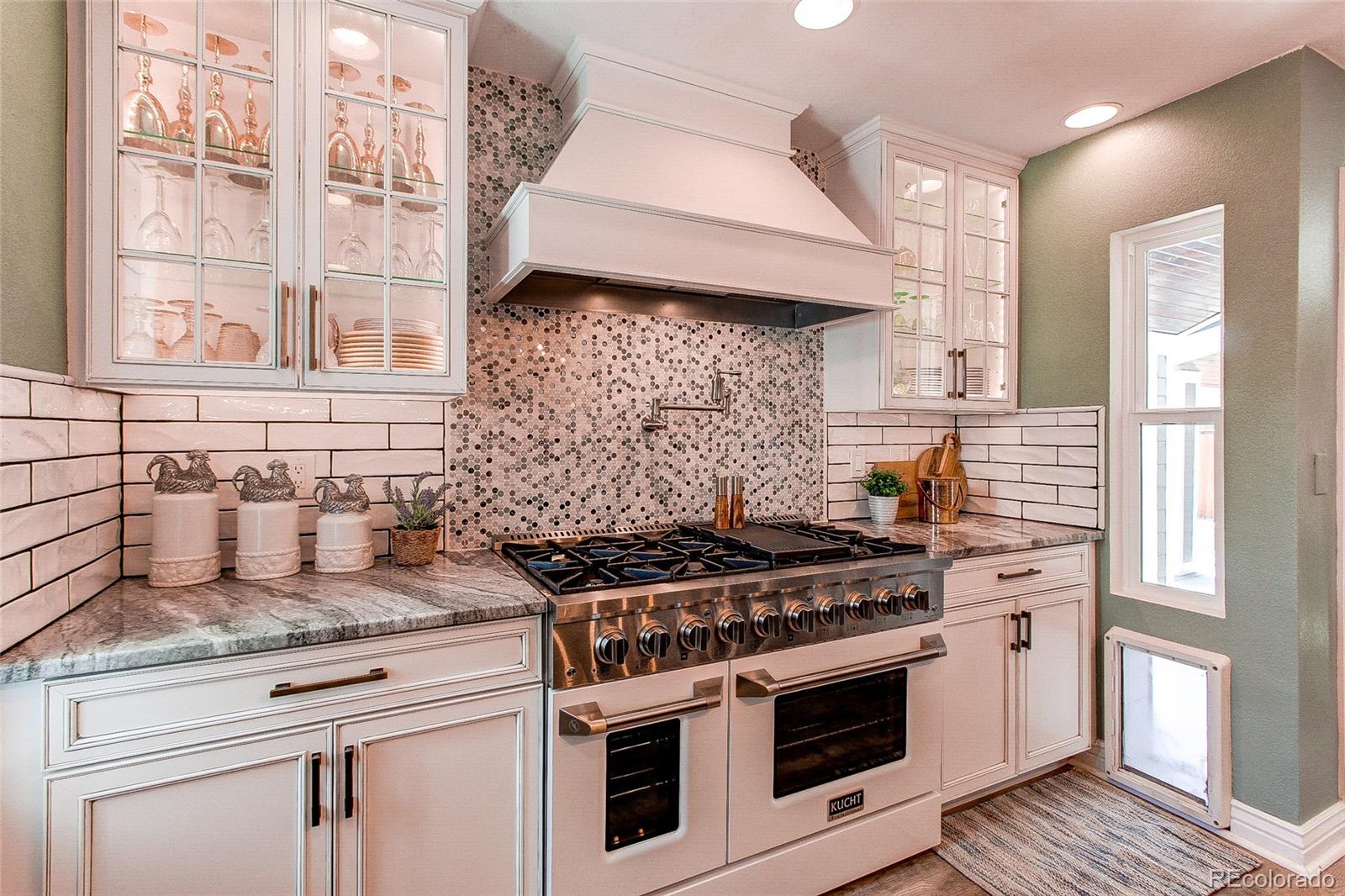 8028 Chaparral Road Lone Tree, CO 80124 - Photo 2 of 40 a stove top oven sitting inside of a kitchen