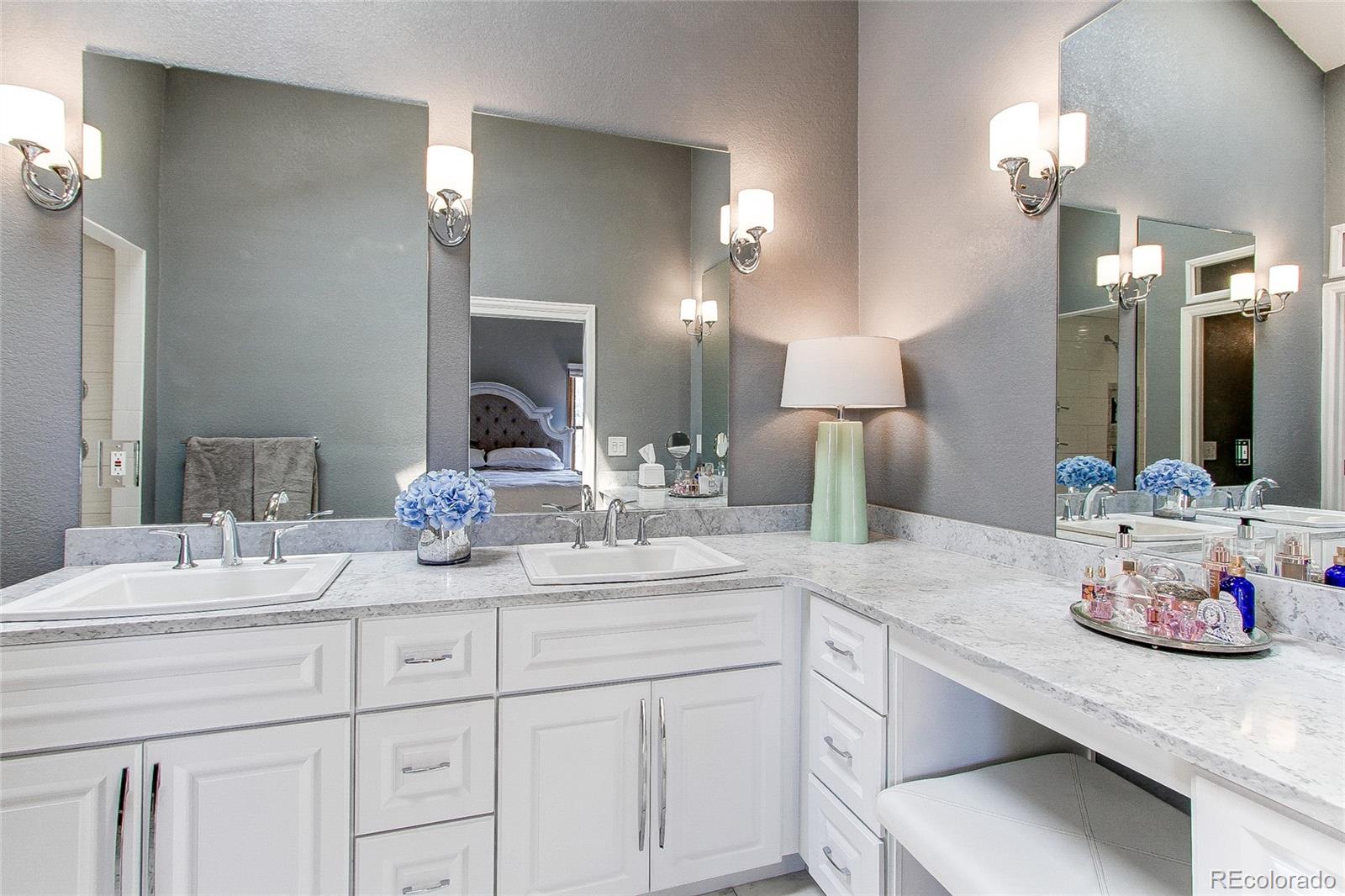 8028 Chaparral Road Lone Tree, CO 80124 - Photo 23 of 40 a bathroom with a sink double vanity and a mirror