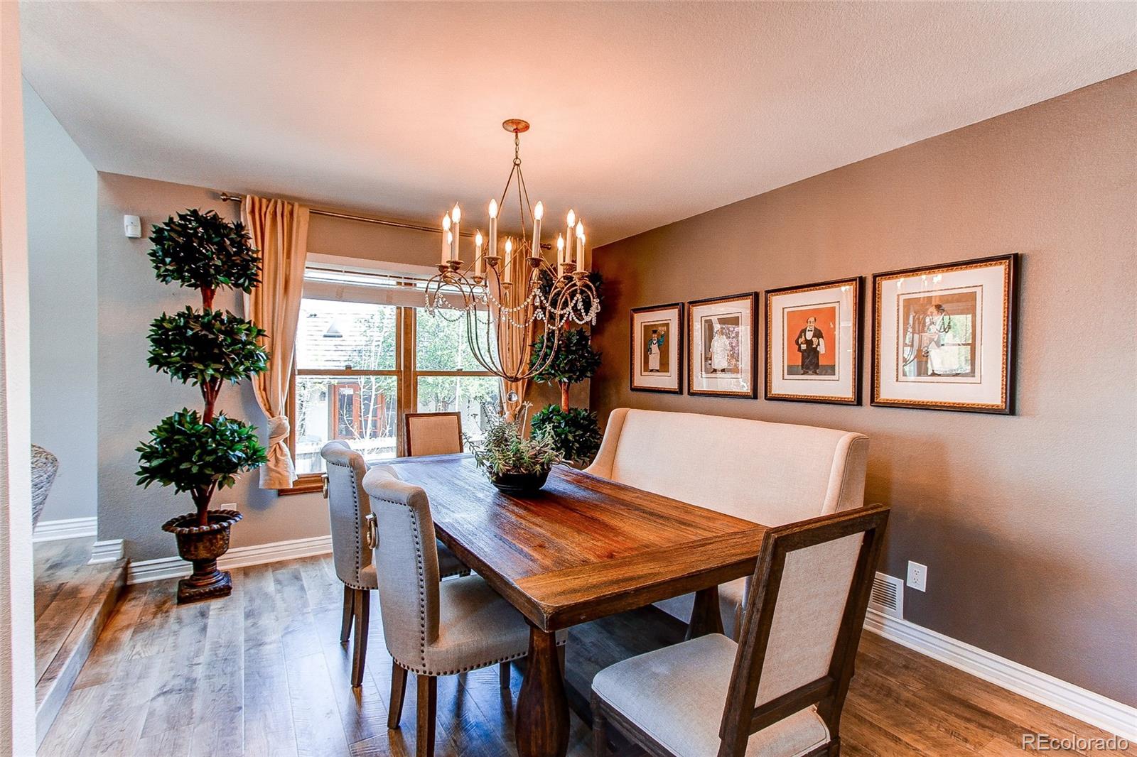 8028 Chaparral Road Lone Tree, CO 80124 - Photo 10 of 40 a view of a dining room with furniture window and wooden floor
