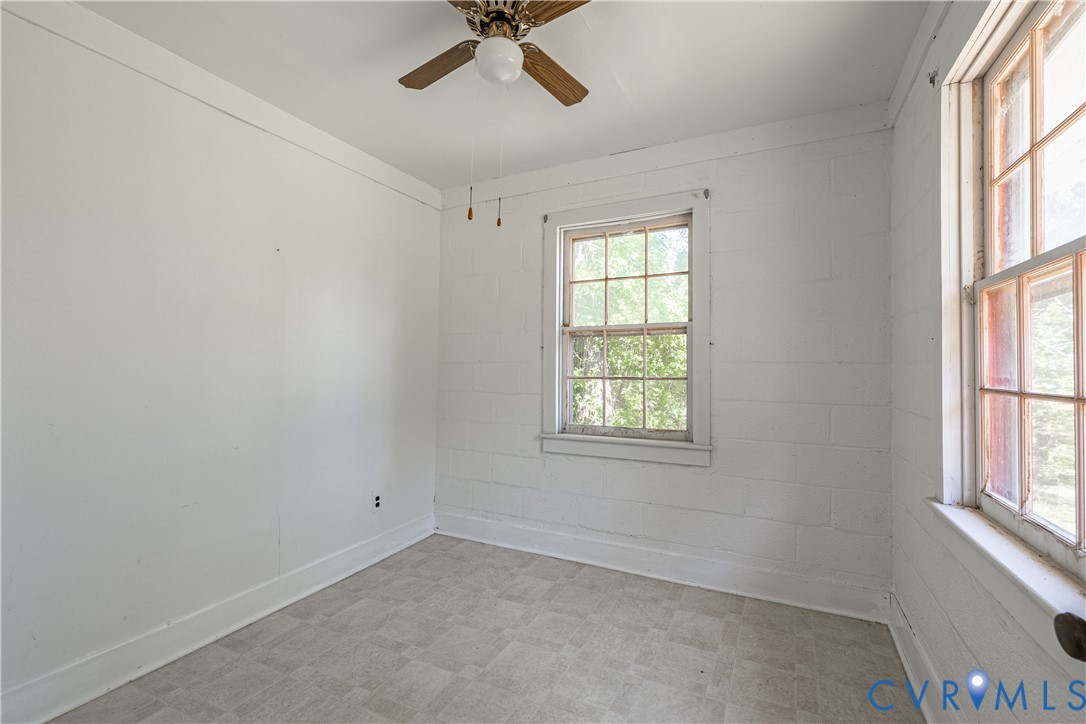 933 Pleasant Point Road Surry, VA 23883 - Photo 18 of 45 an empty room with windows and fan