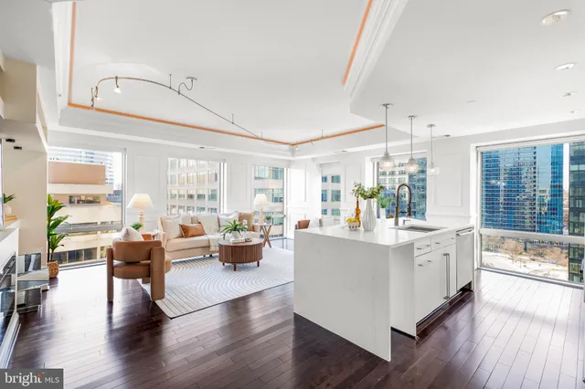 a kitchen that has a lot of cabinets a sink and appliances in it