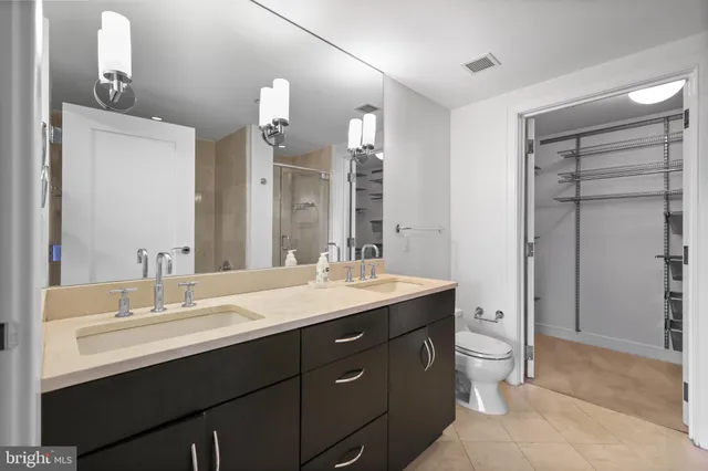 a kitchen with stainless steel appliances kitchen island granite countertop a refrigerator and a sink